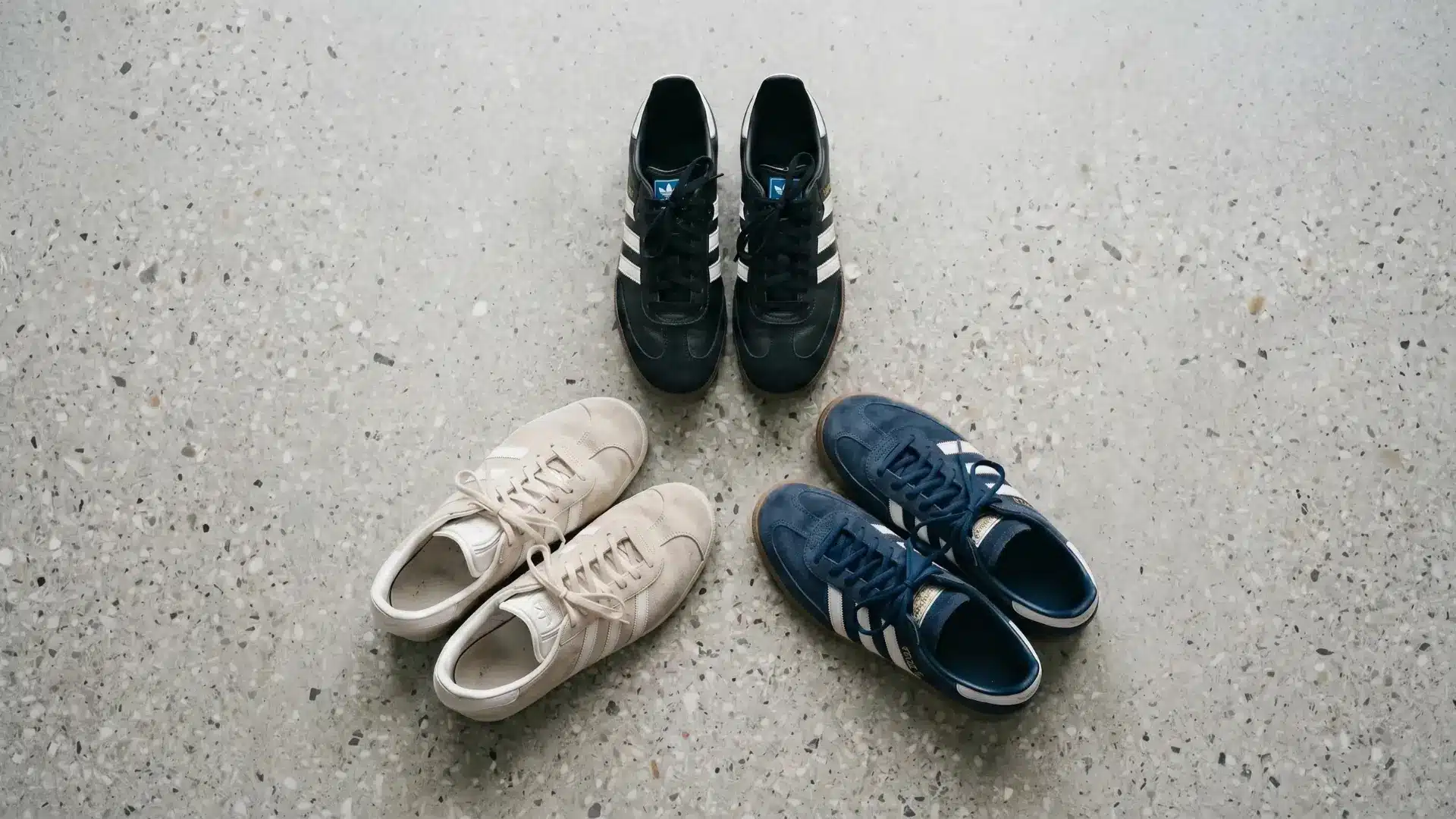 Adidas Samba, Gazelle, and Spezial sneakers flat-lay comparison on grey terrazzo surface
