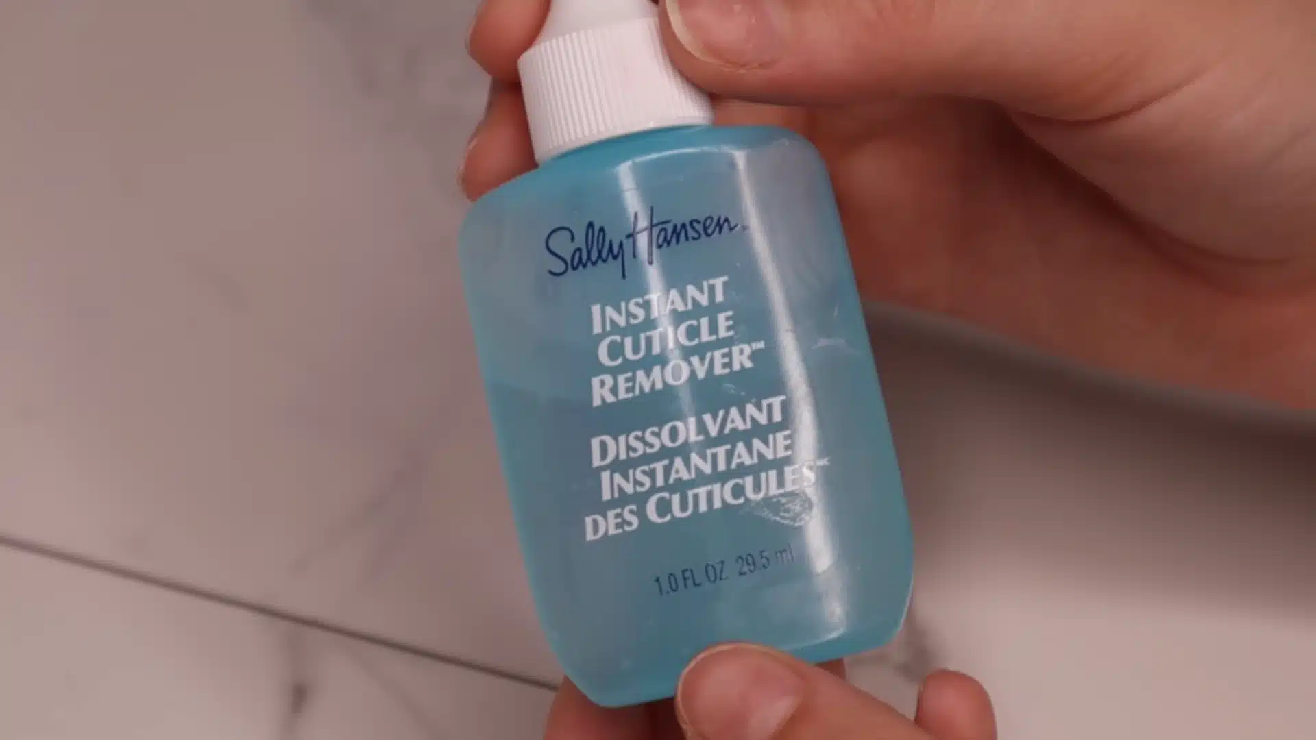 Apply cuticle remover to soften nail cuticles before gently pushing them back