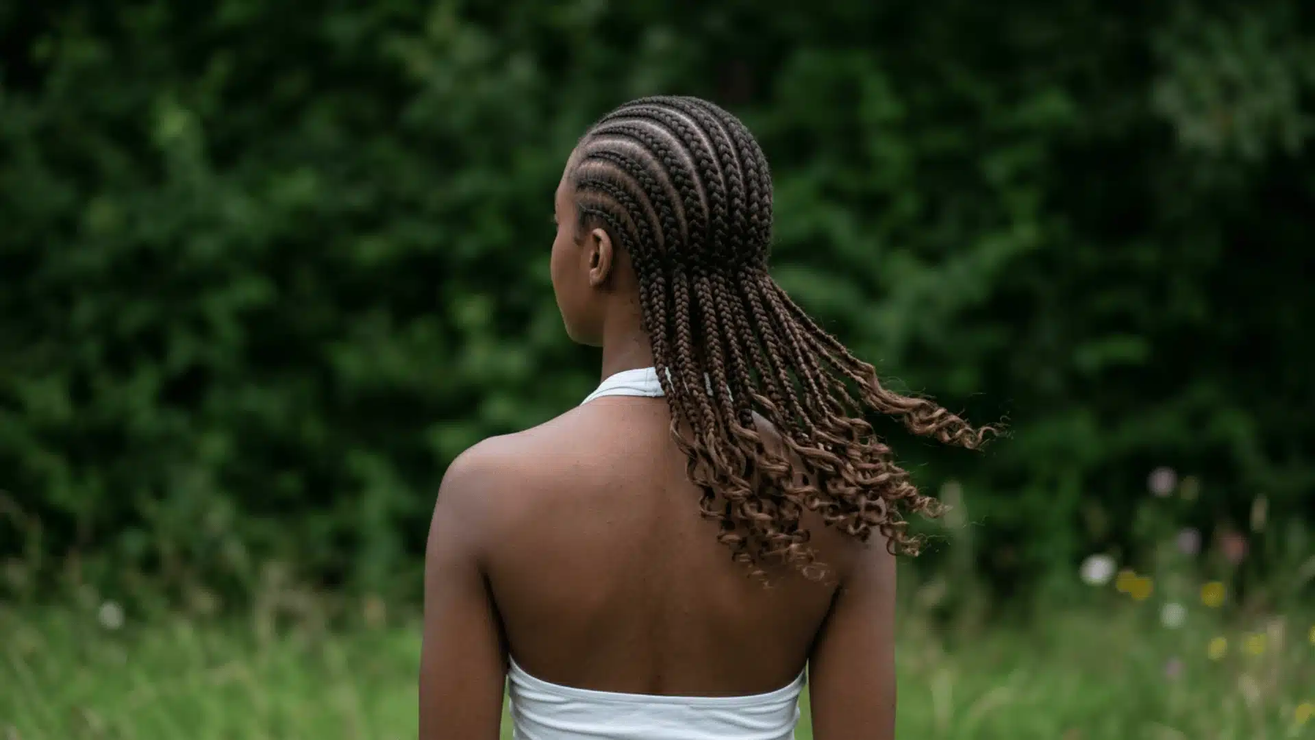 Back view of boho cornrow-to-curl braids with neat scalp cornrows transitioning to loose curls at the nape