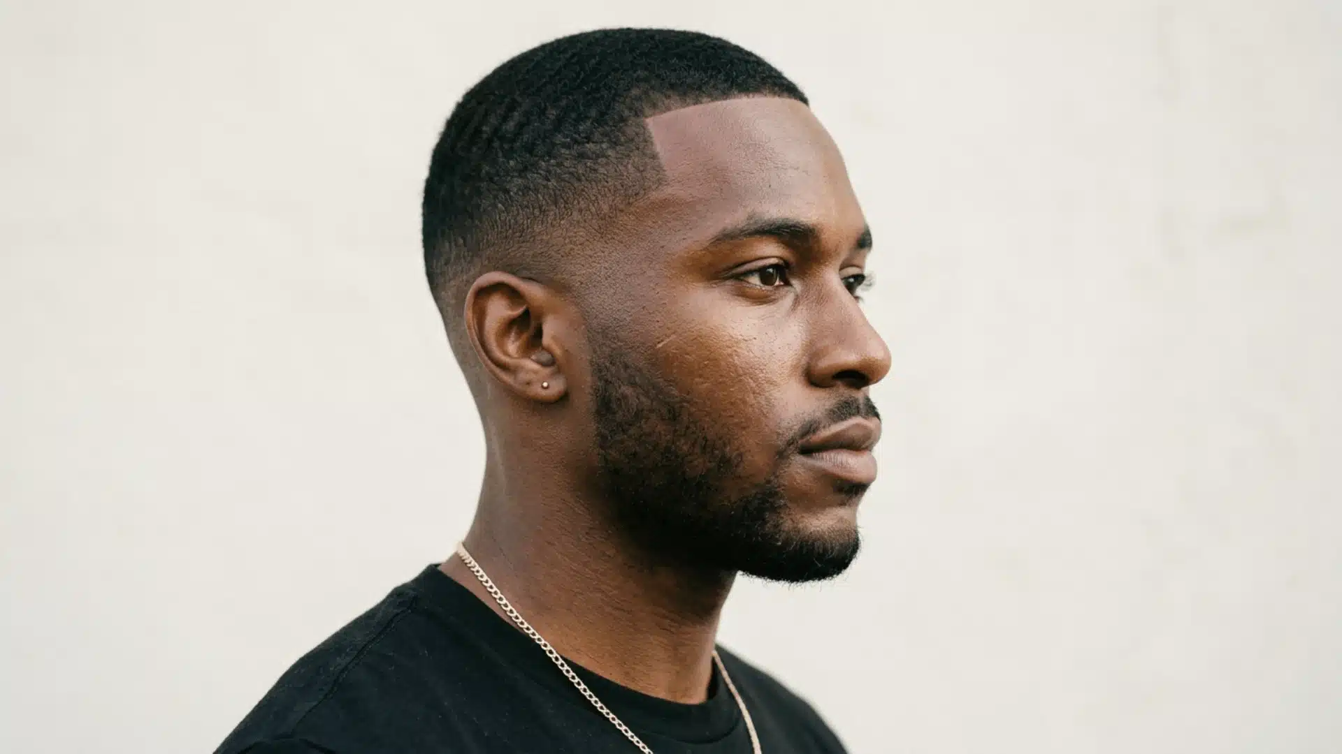 Black man with a lineup buzz cut featuring razor sharp forehead and temple edges
