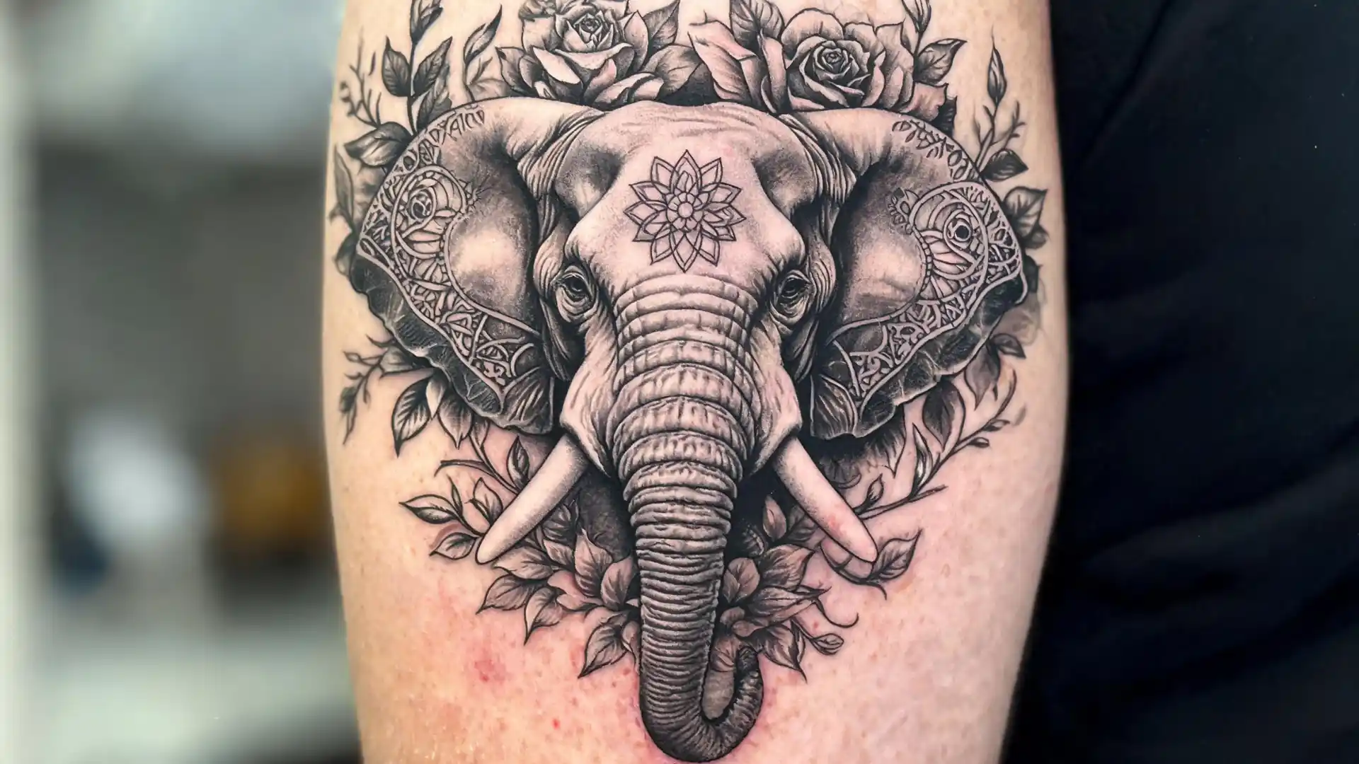 Black and grey elephant tattoo with roses and mandala details