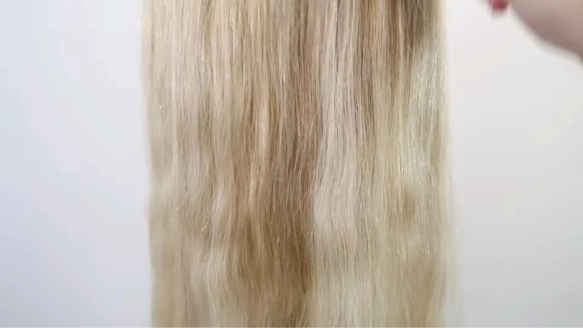 Blonde hair fully brushed and detangled before braiding, showing smooth strands separated into natural sections in preparation for a three-strand braid.