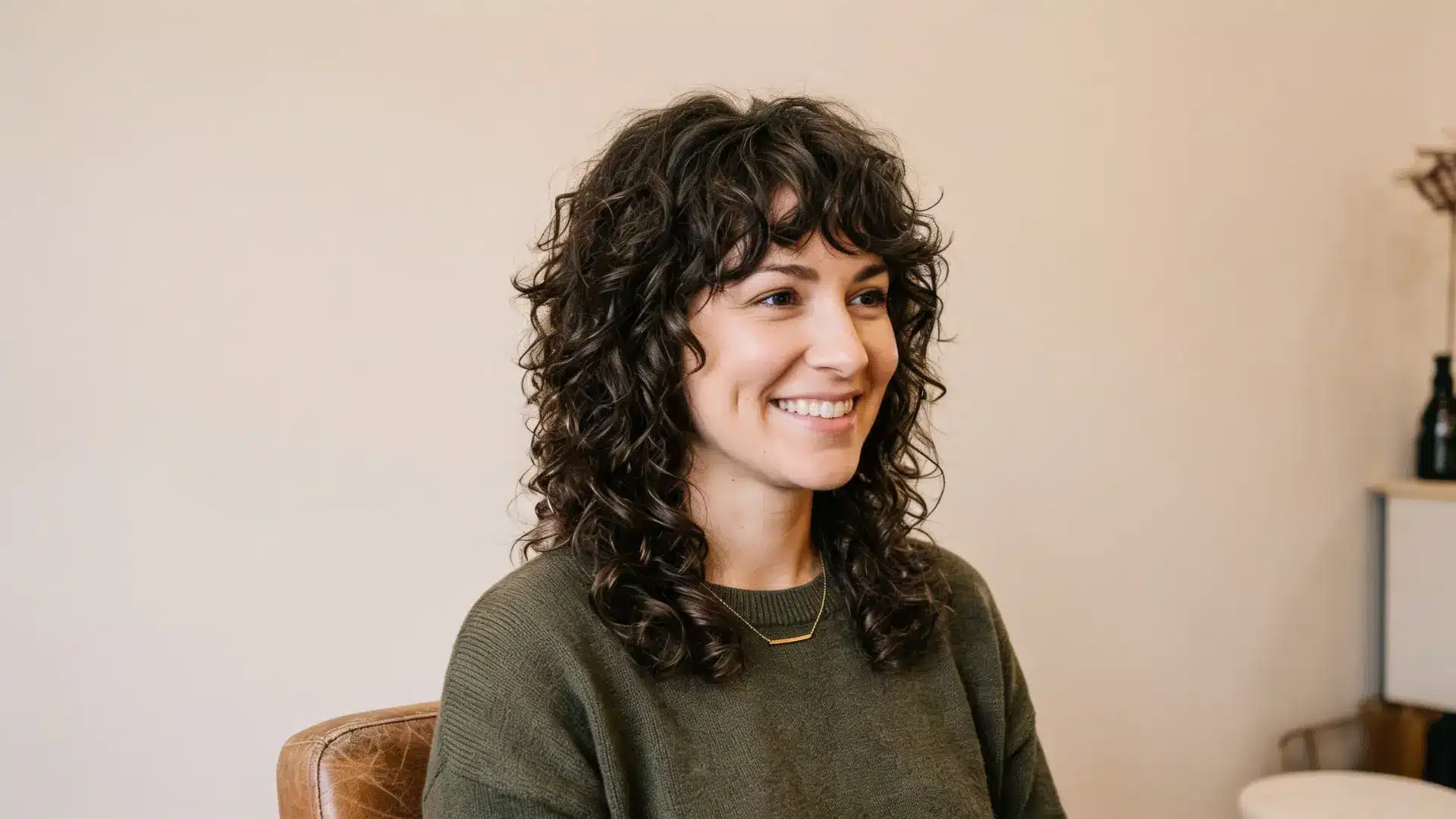 Curly shag with layered texture and side volume for facial balance.