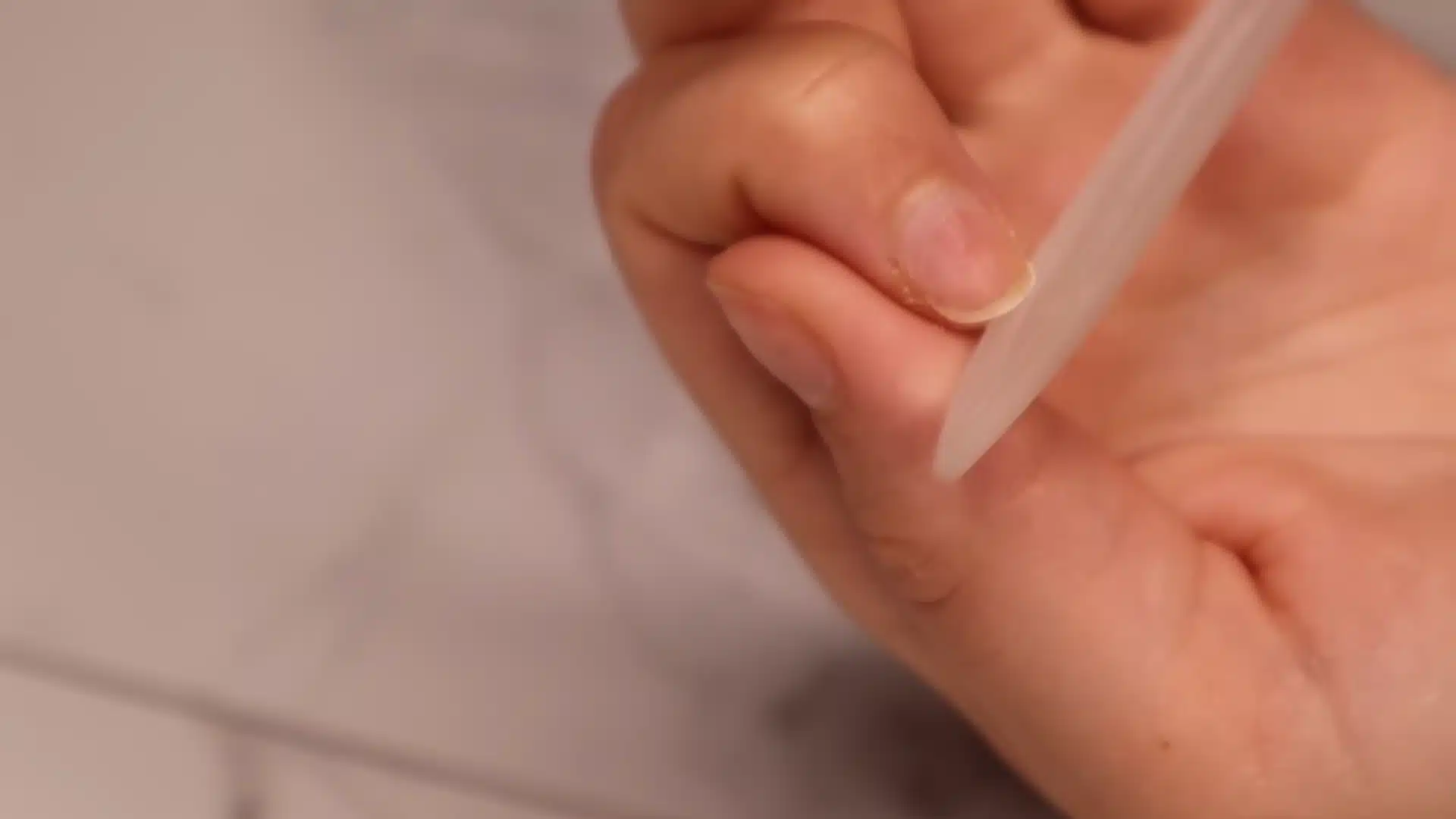 File the nail edge gently with a crystal nail file during beginner cuticle care