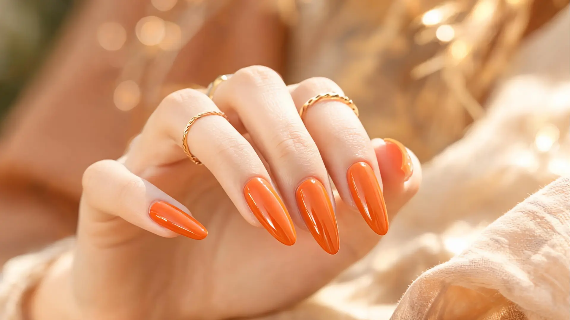 Glossy orange almond nails