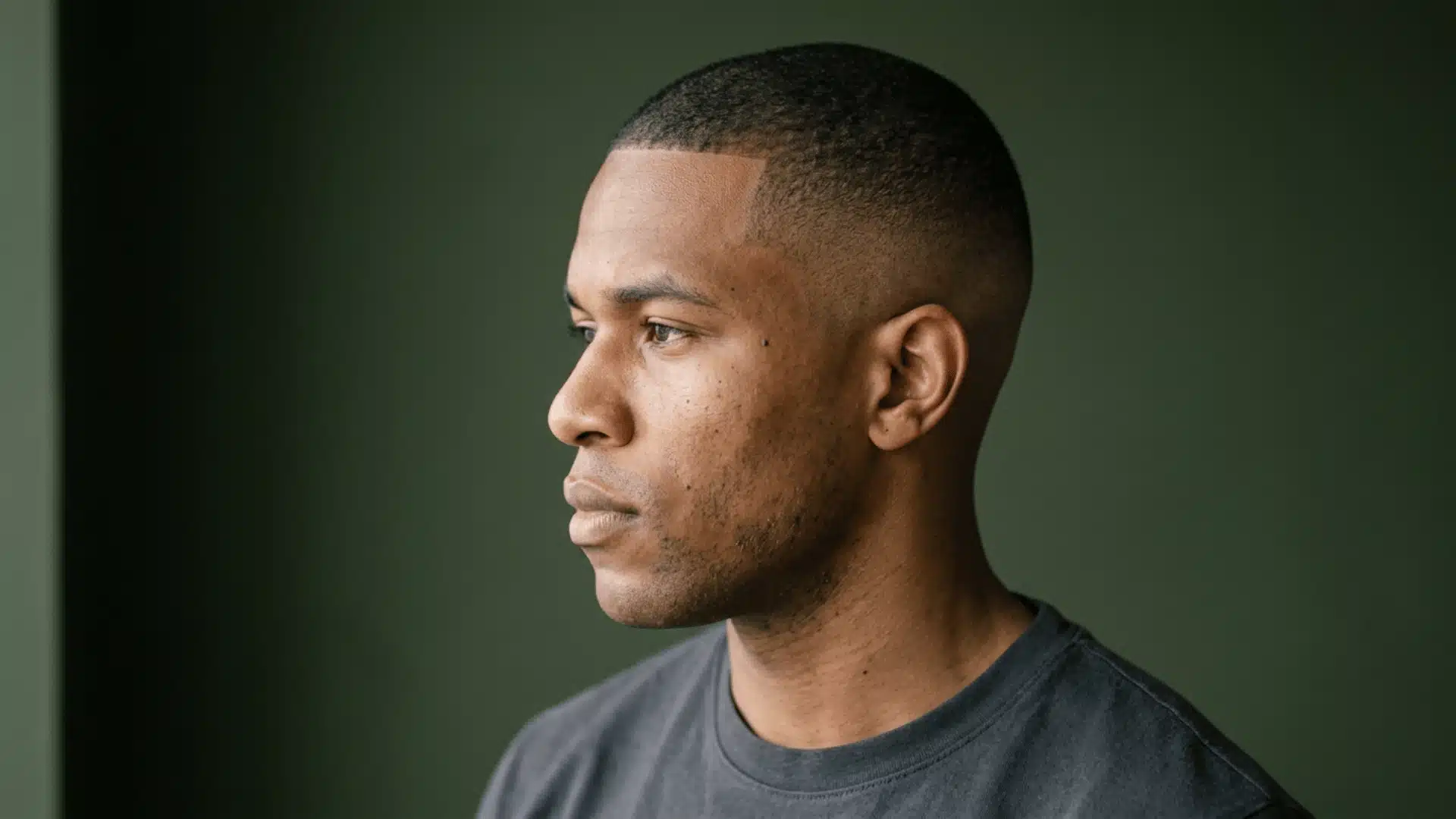 Man with a high fade buzz cut showing strong contrast near the temples