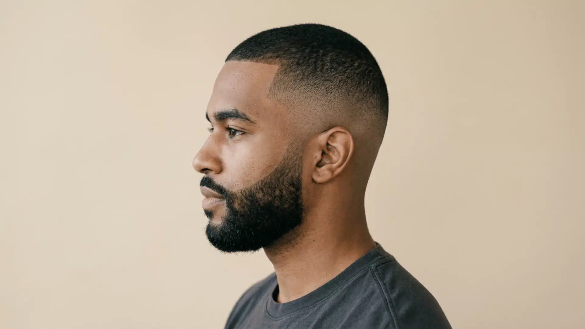 Man with a mid fade buzz cut featuring balanced faded sides and a textured short top
