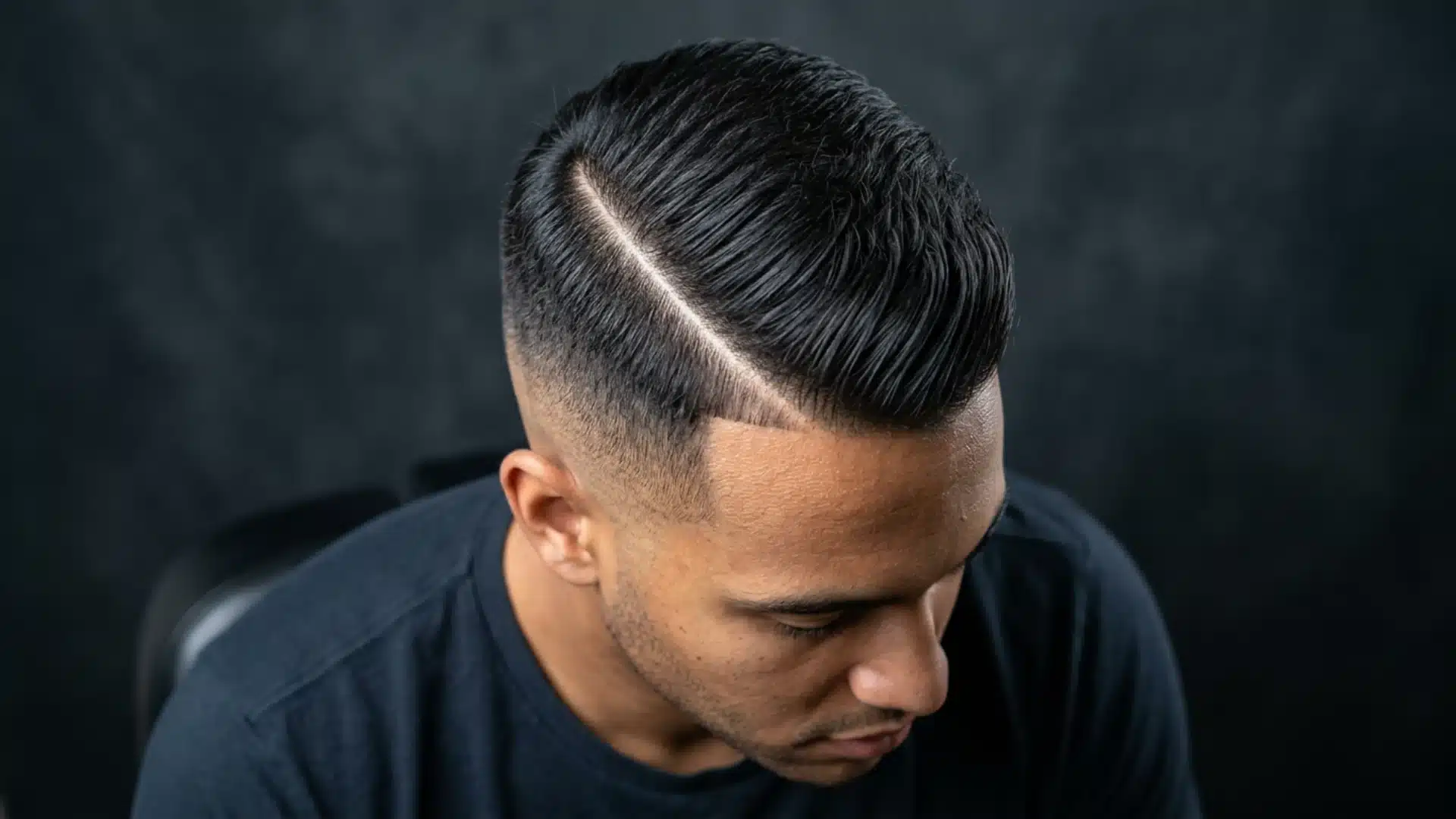 Overhead close-up of hard part side swept crew cut, shaved parting line clearly visible