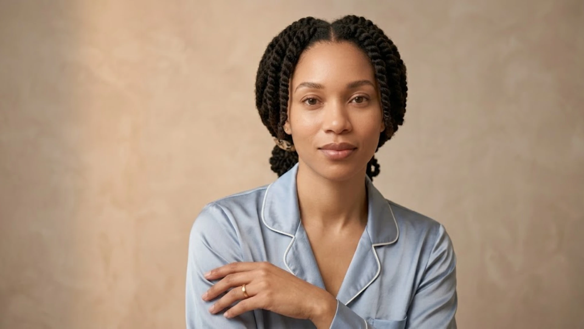 Protective strand twists in a comfortable nighttime setting.