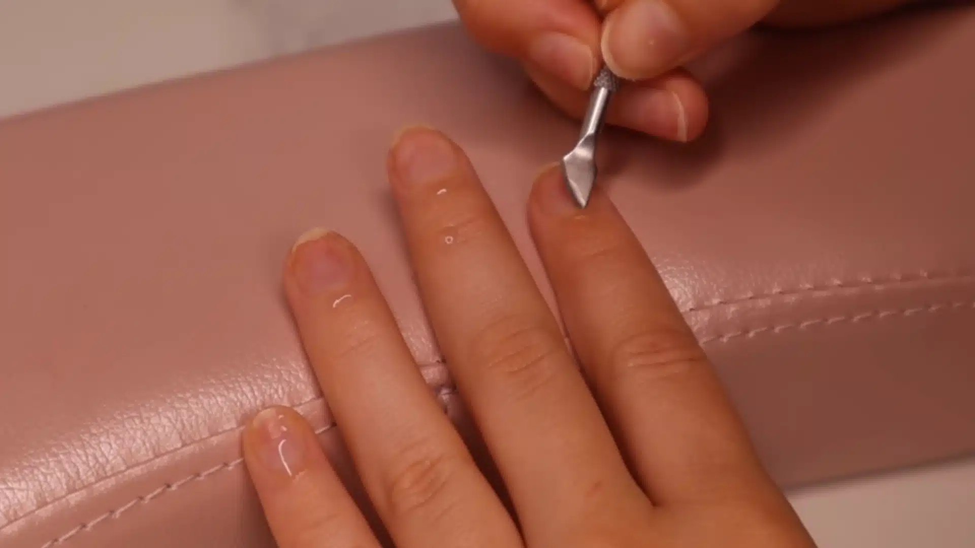 Remove cuticle from the nail plate with a gentle scraper for smooth nail prep