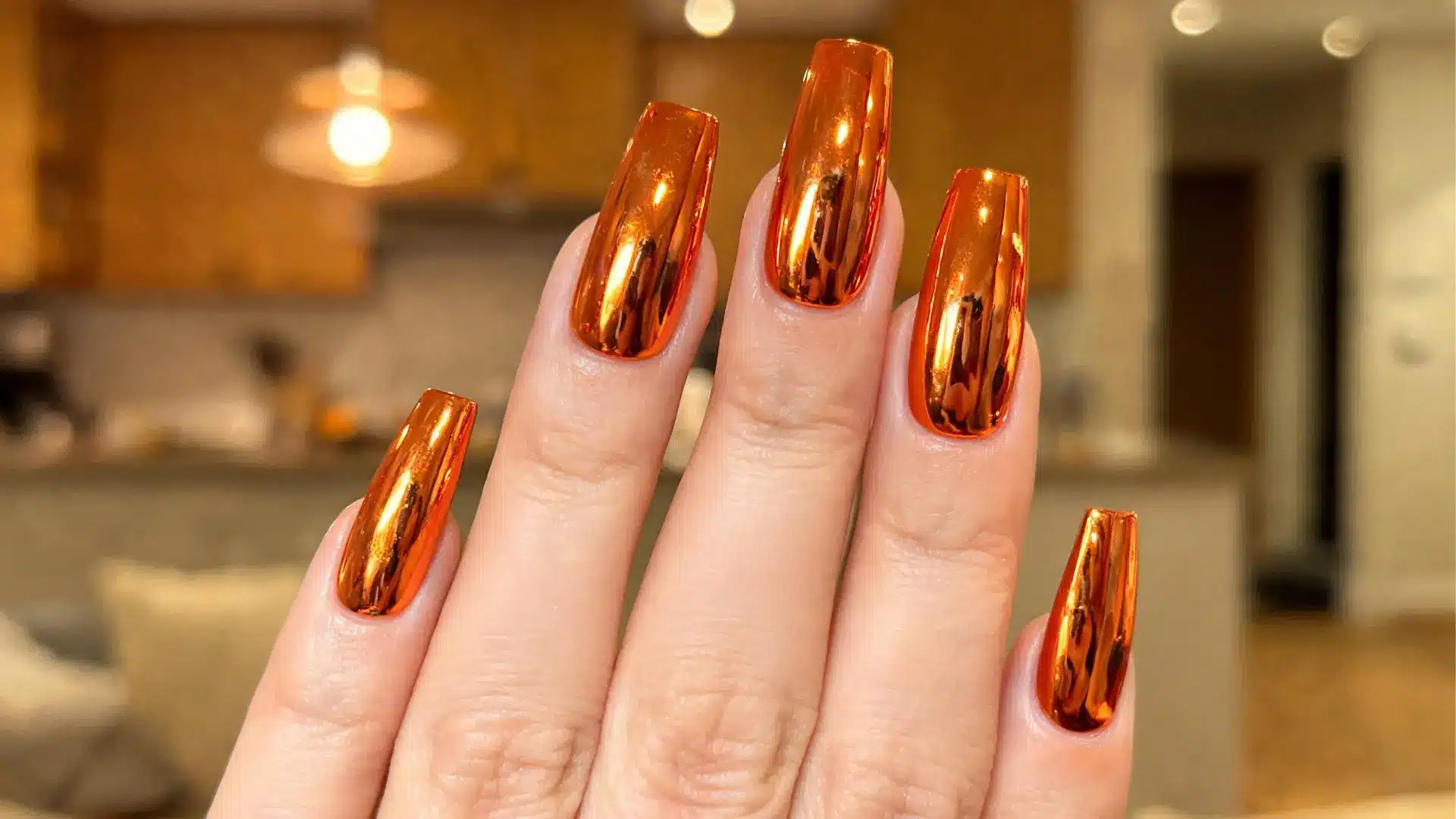 Shiny orange chrome nails