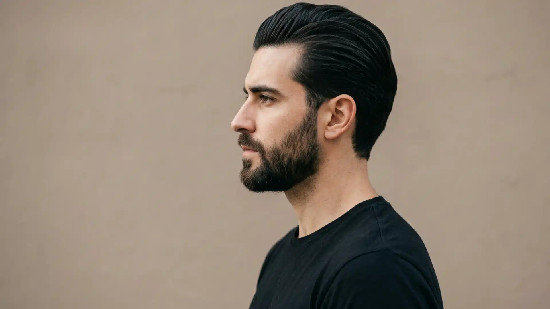 Slick-back hairstyle with hair combed backward for a clean finish