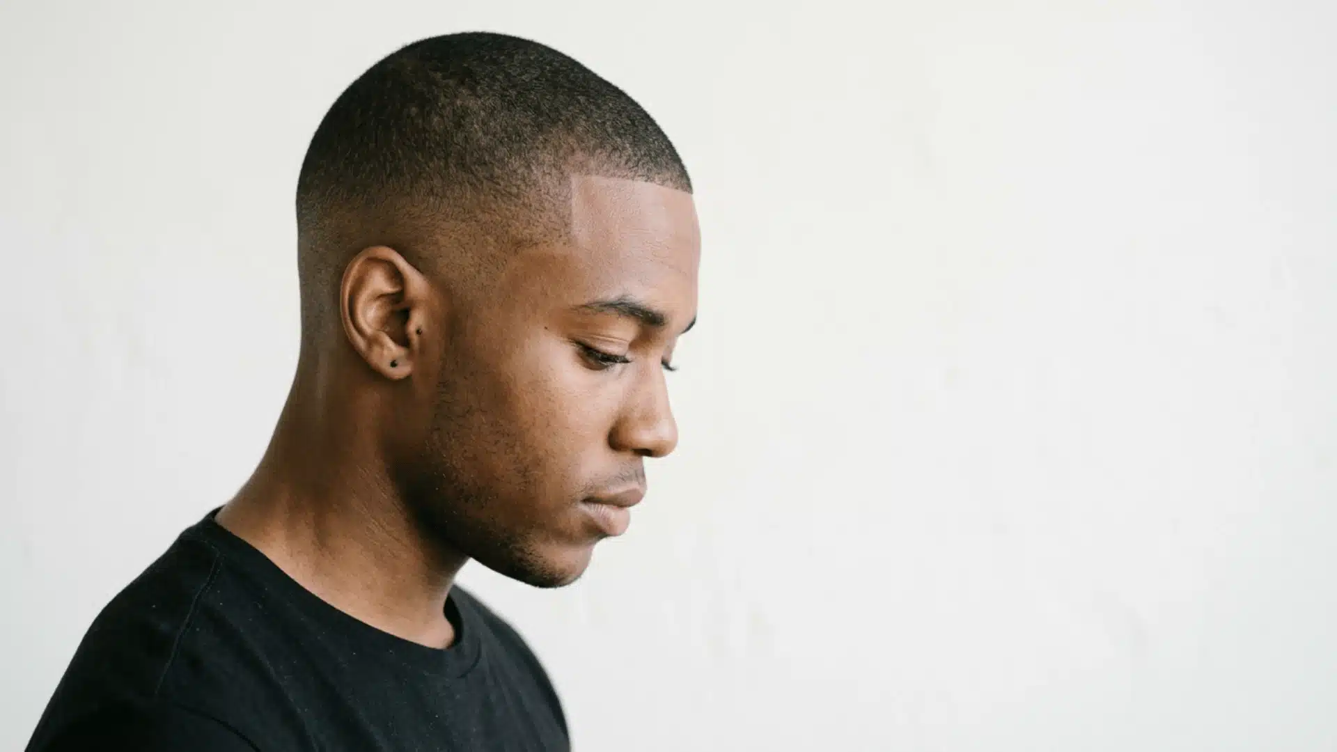 Soldier inspired man with a military buzz cut featuring short regulation style hair and tapered sides