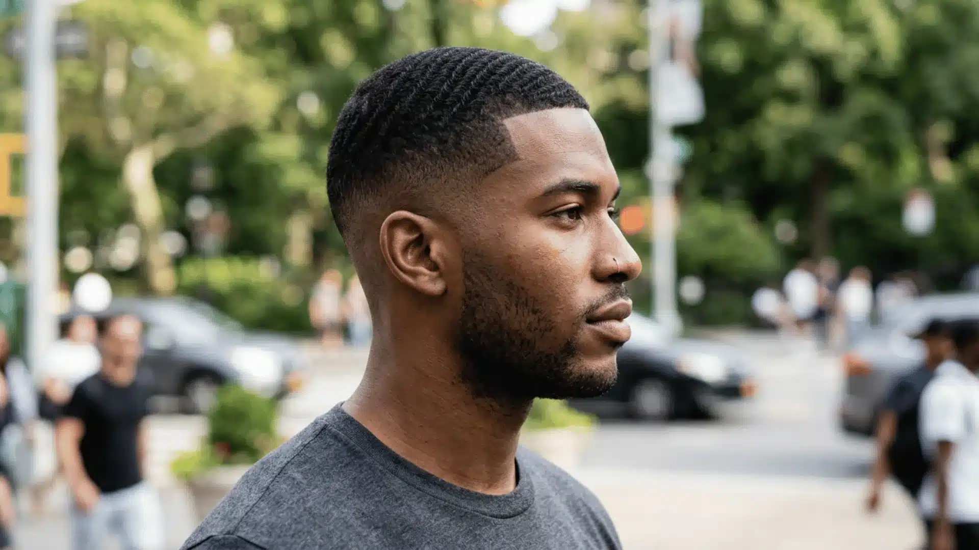 South Asian man with a temple fade buzz cut and sharp faded temples with a fuller top