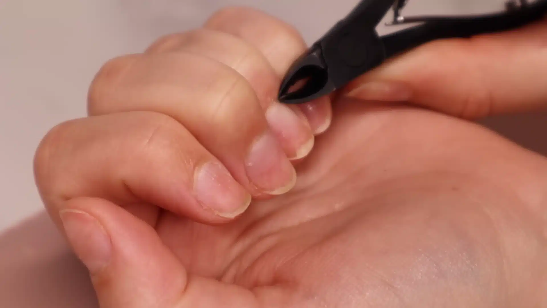 Wash hands and trim only loose skin with cuticle nippers after cuticle remover