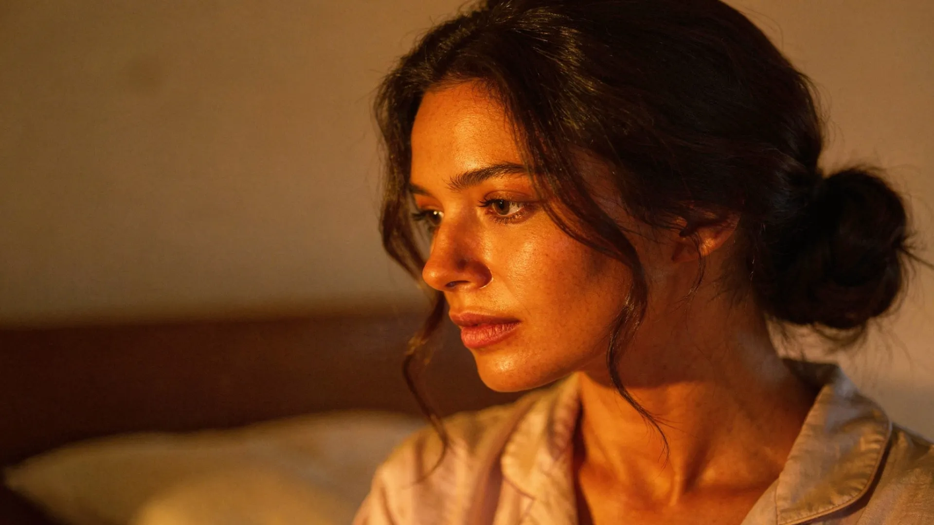 Woman with a relaxed low bun preparing for bedtime.
