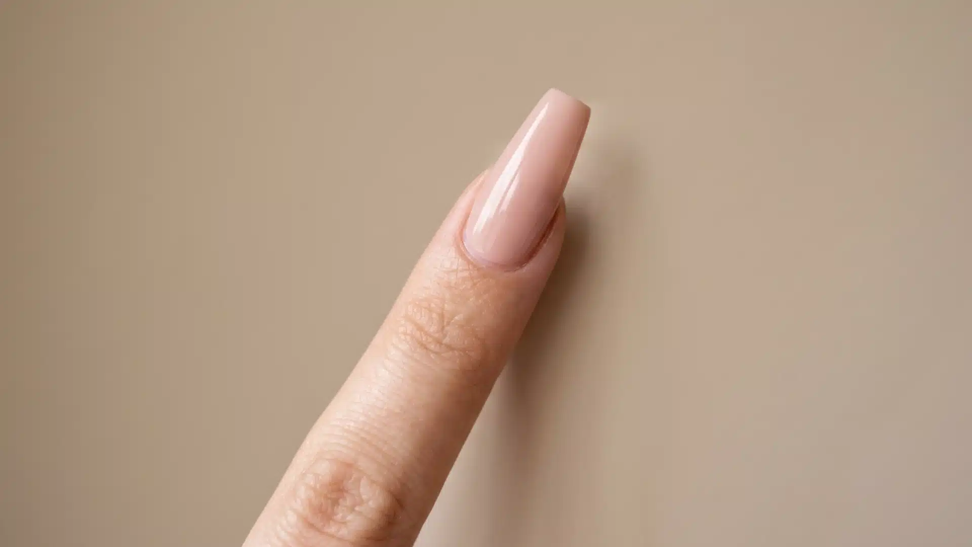 Close-up of a coffin nail shape with long tapered sides and squared-off flat tip