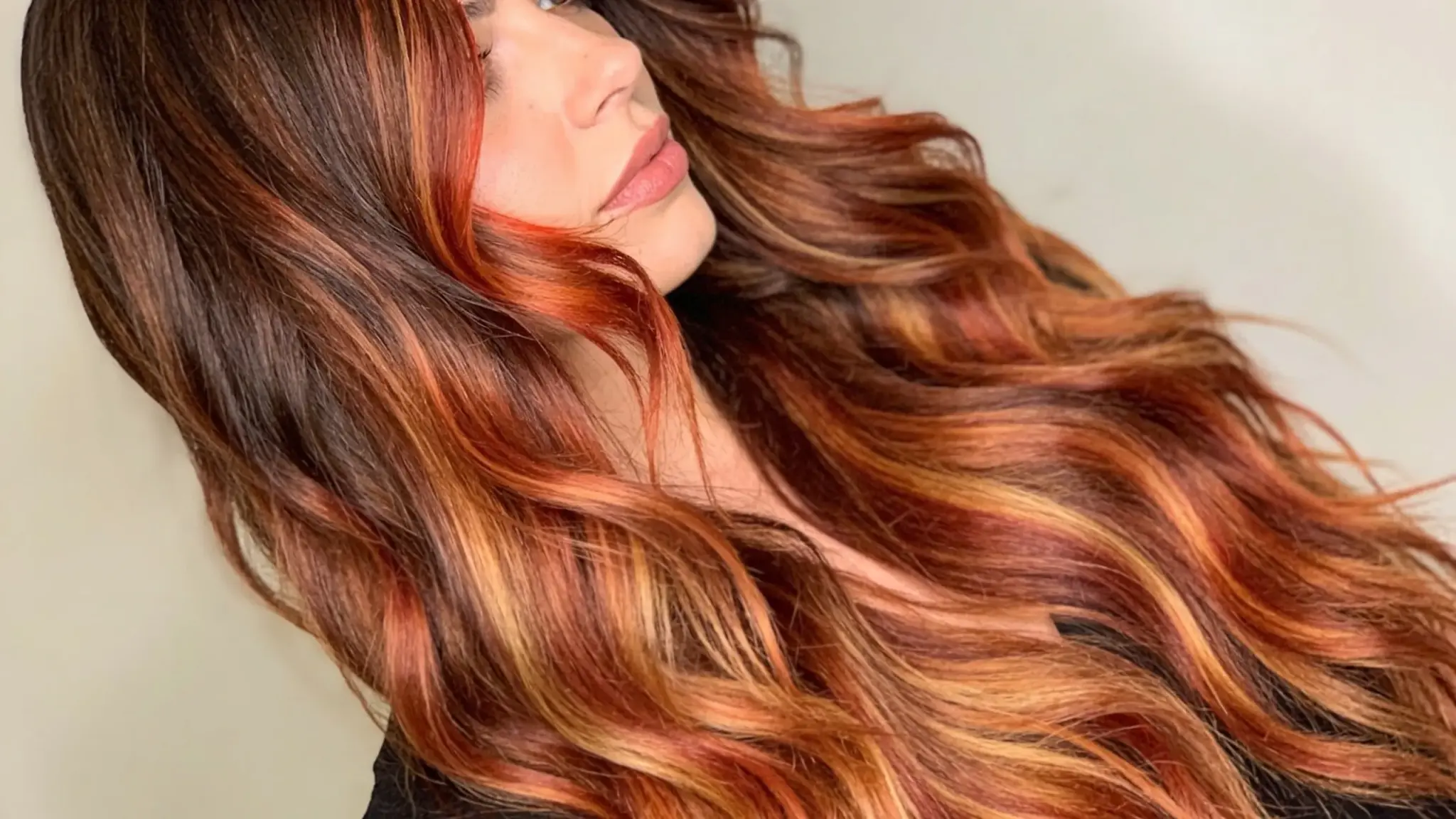 copper balayage with warm auburn tones on long flowing brown hair with rich highlights