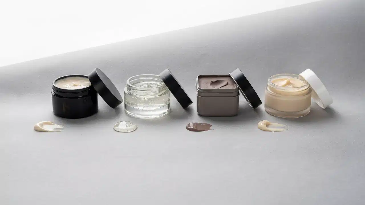 four hair styling products showing pomade gel clay and wax textures in realistic grooming setup