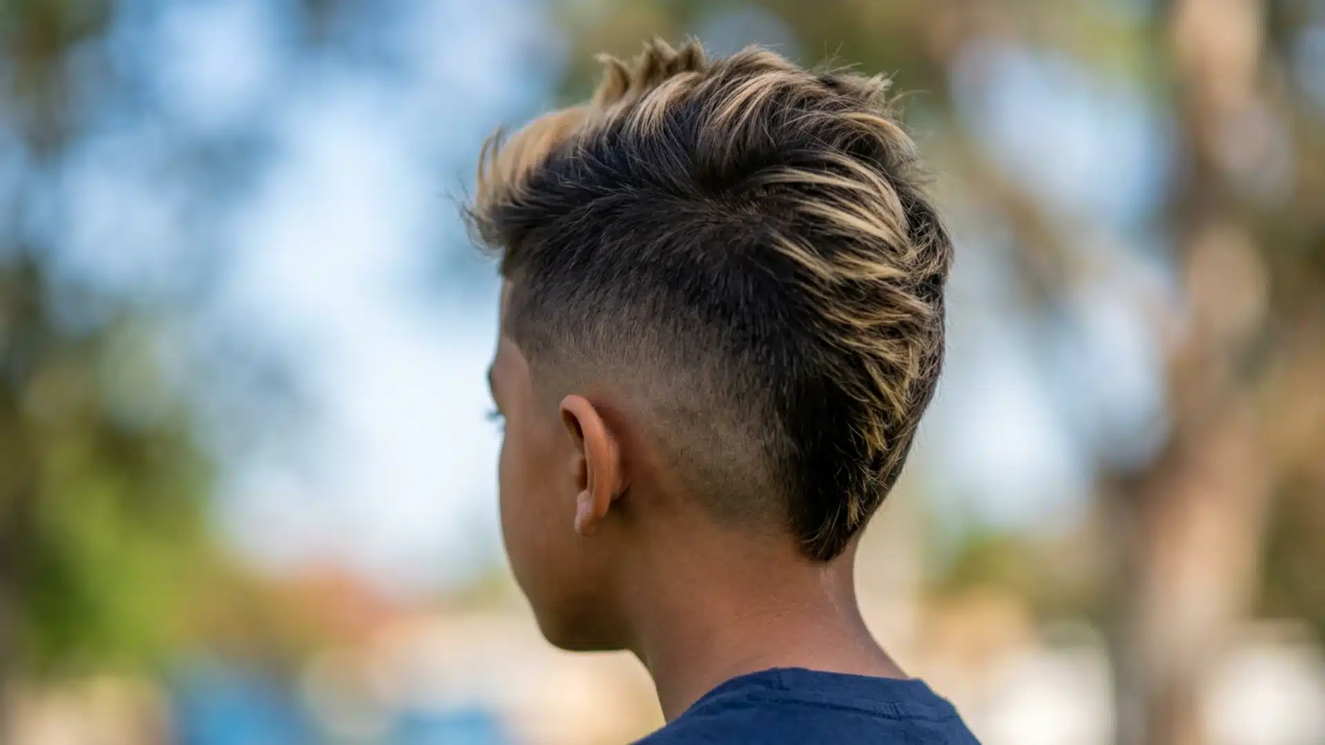 Mixed boy with a burst fade and fro-hawk shaped through the center