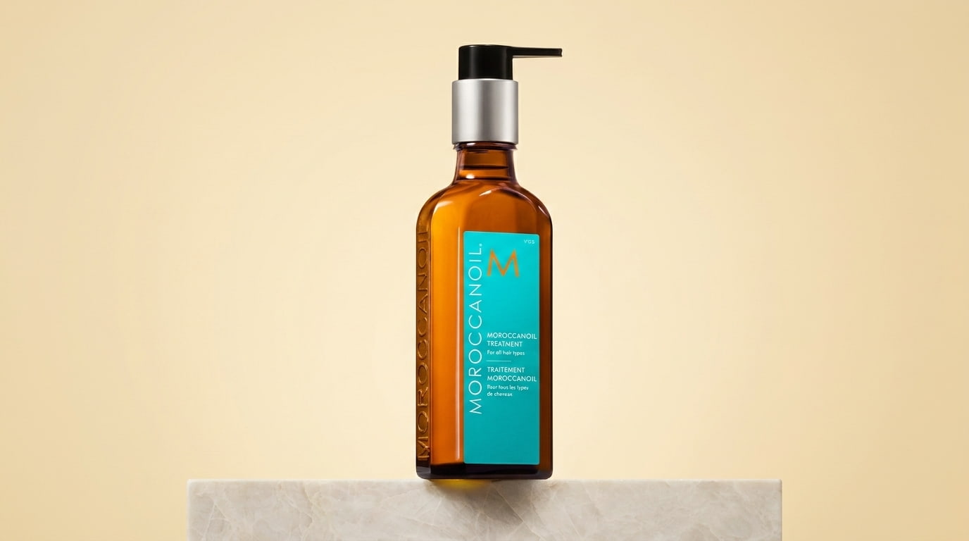 moroccanoil treatment original bottle displayed on a light stone block against a soft beige background