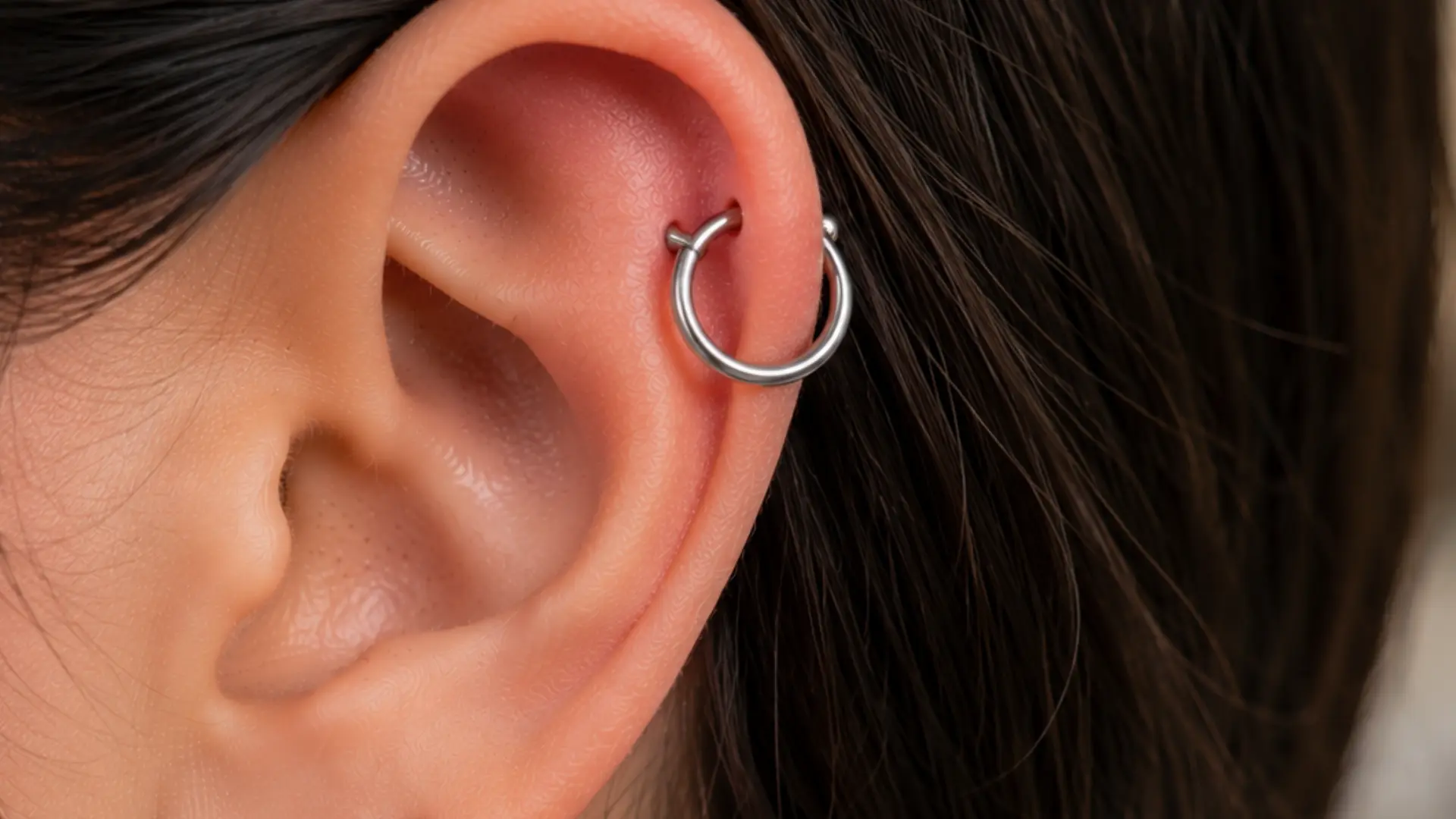 Orbital ear piercing with seamless hoop