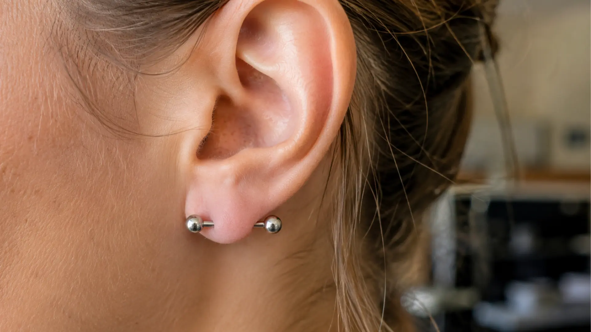 Realistic transverse lobe piercing with horizontal barbell