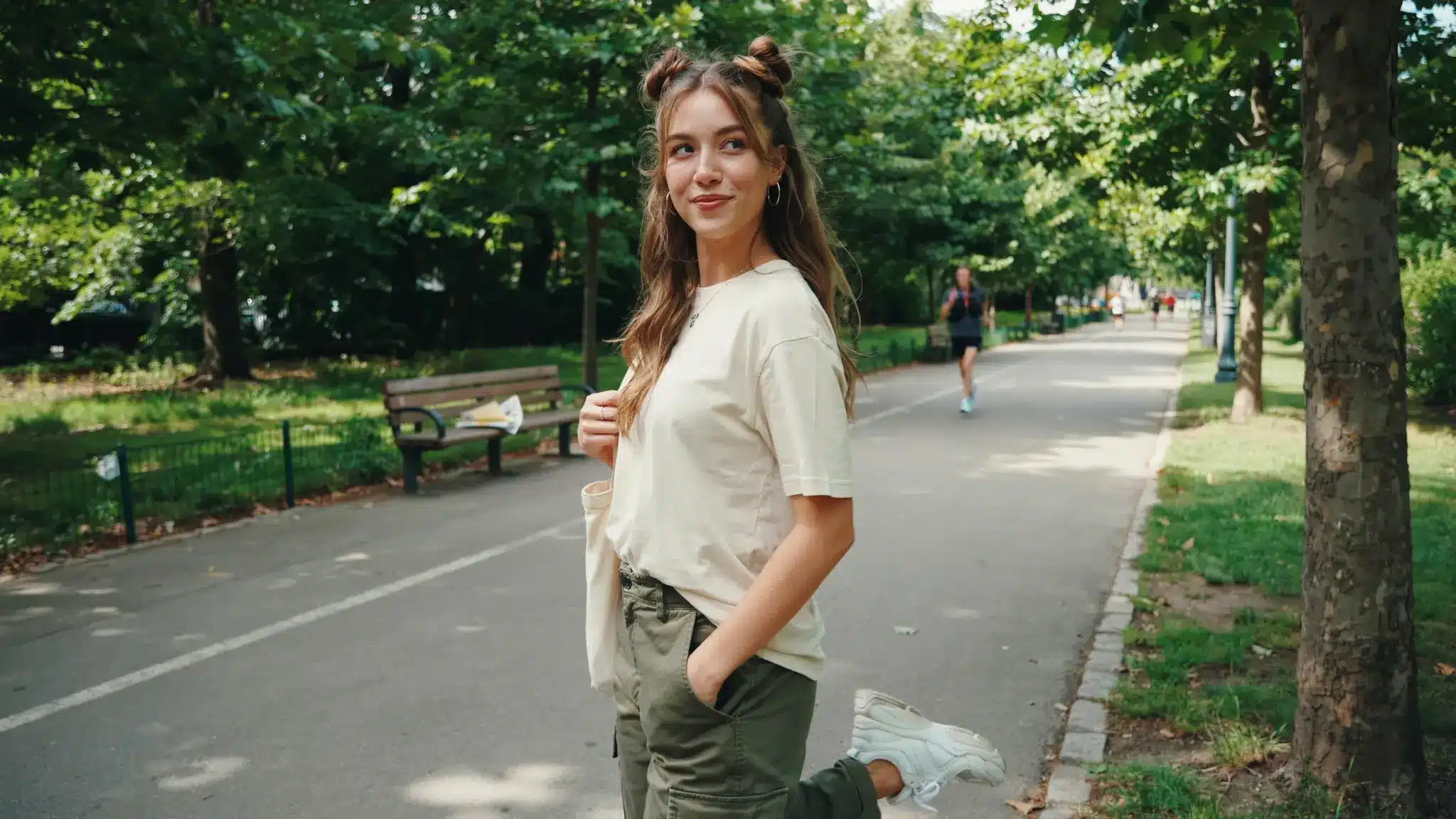 woman with half up space buns hairstyle and loose hair in outdoor setting