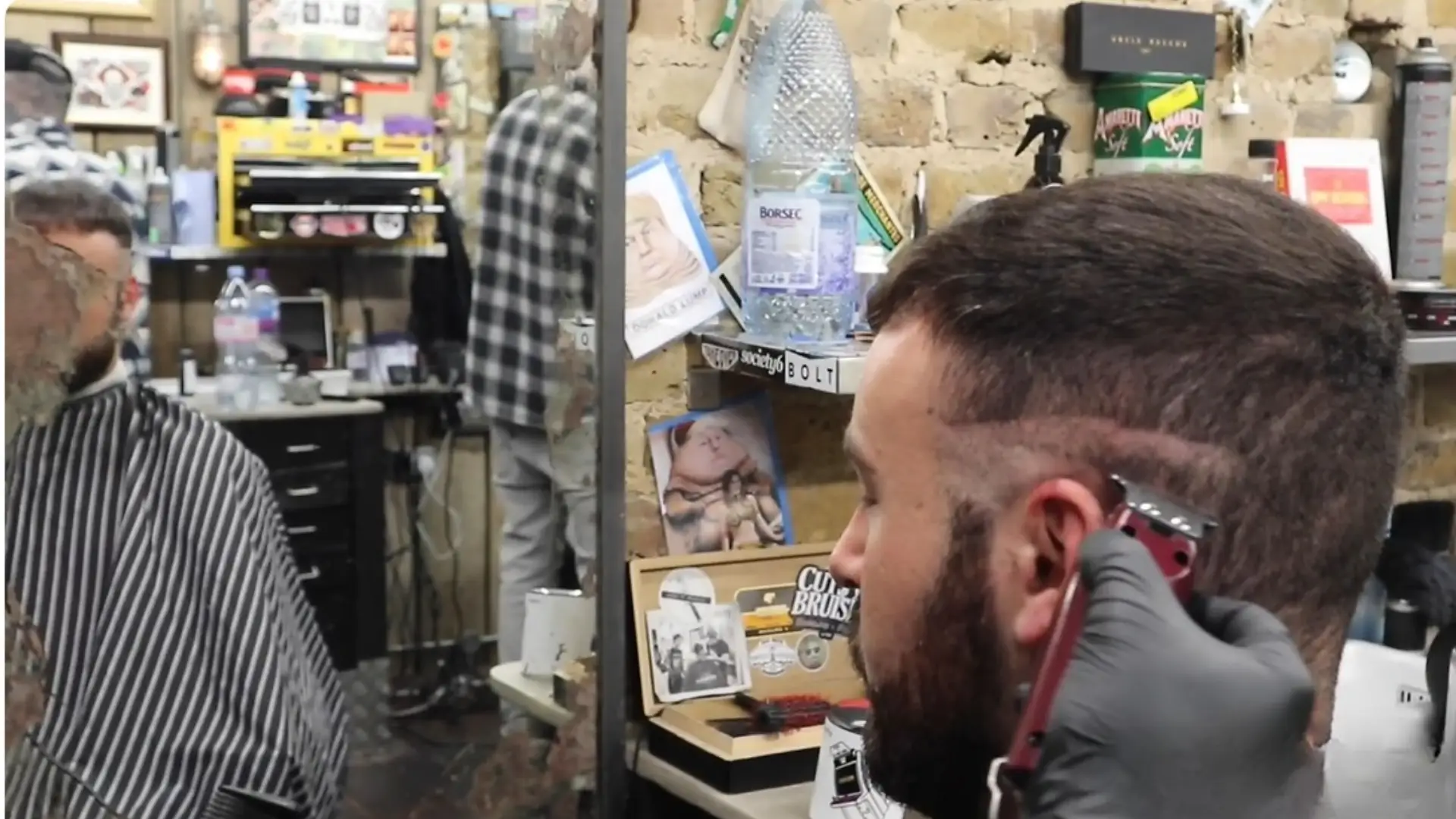 YouTube video of barber using clippers for fade haircut with related haircut tutorials listed on sidebar