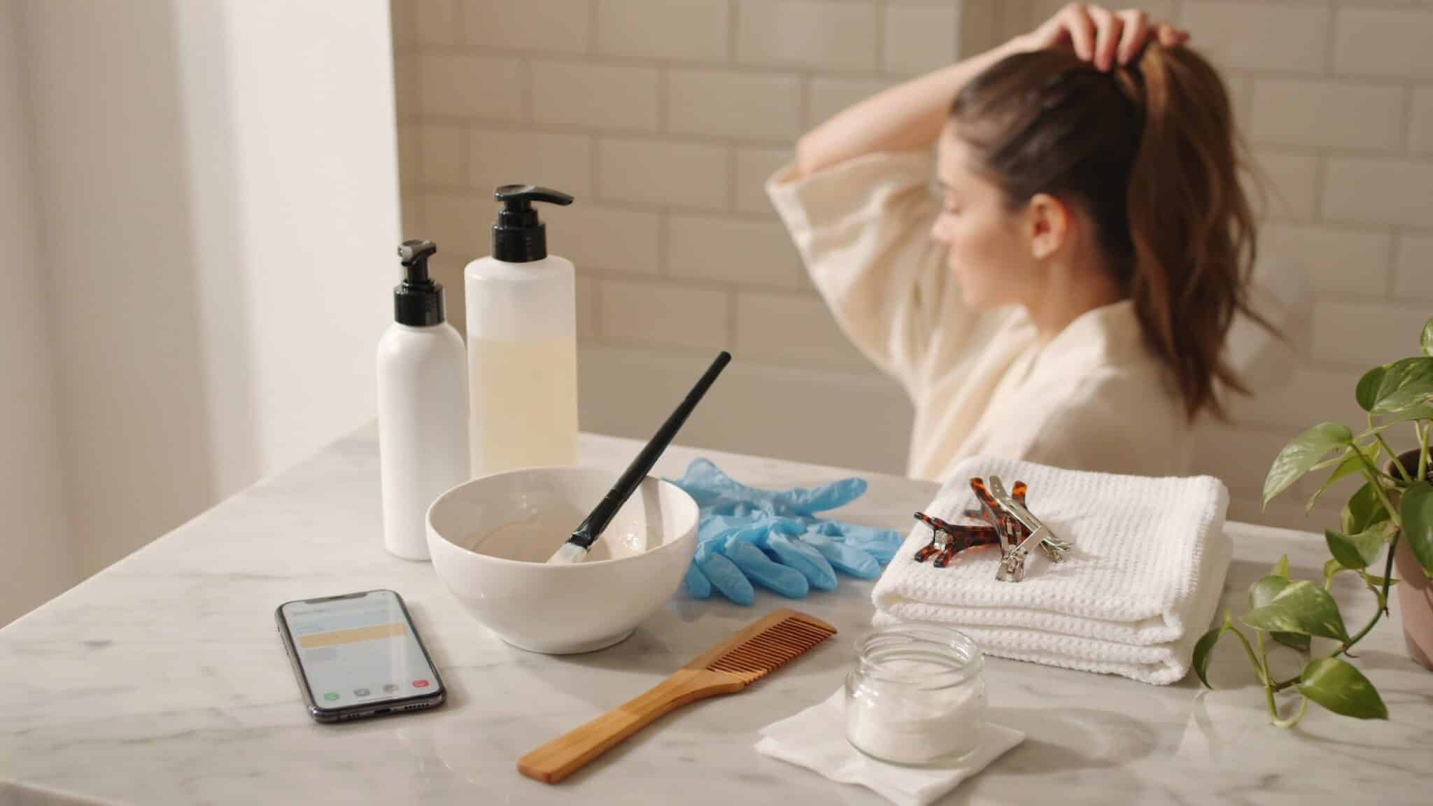 hair dye preparation tools arranged on a bathroom counter before coloring