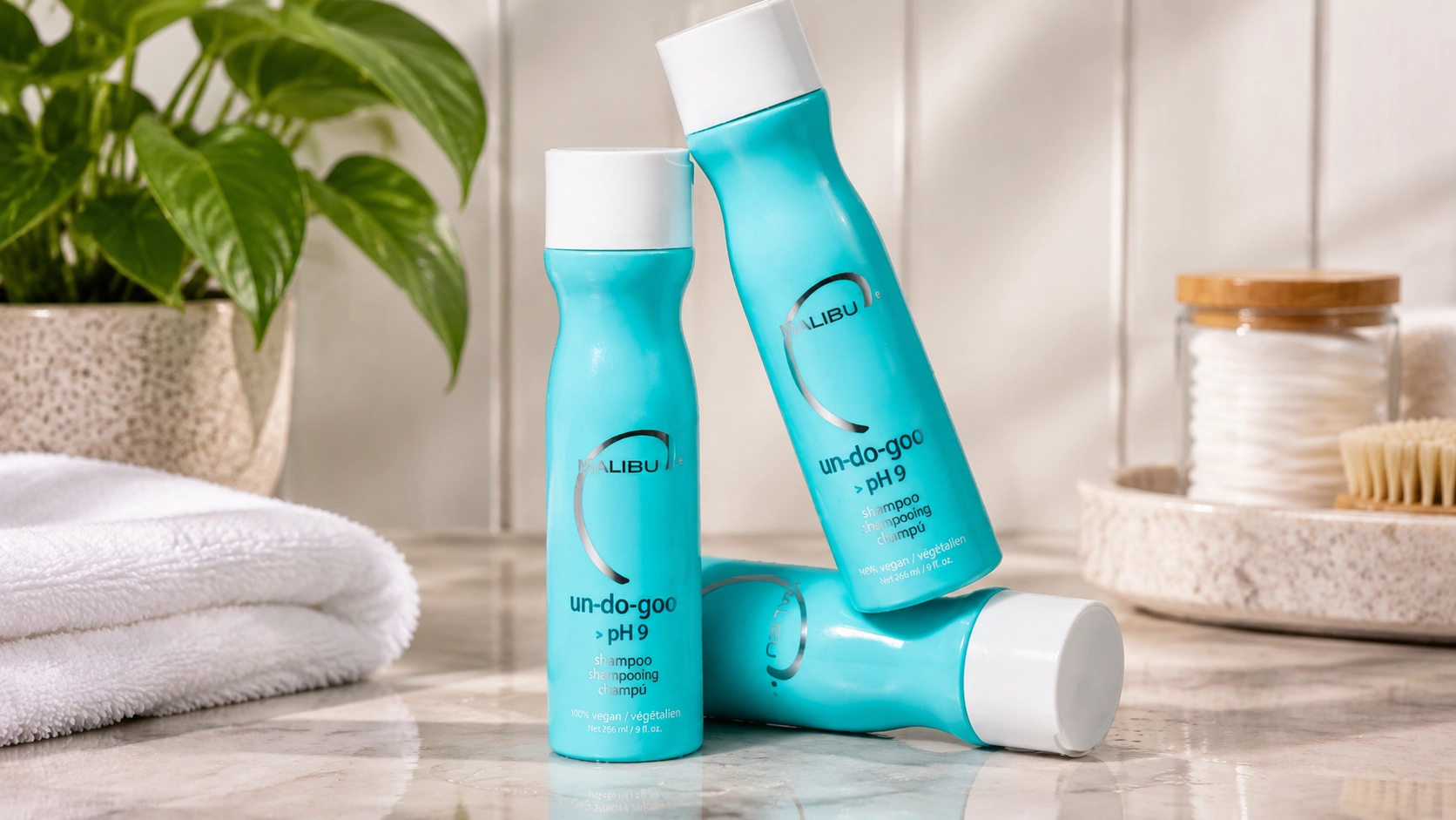 malibu c un-do-goo clarifying shampoo bottles arranged on a bright bathroom counter