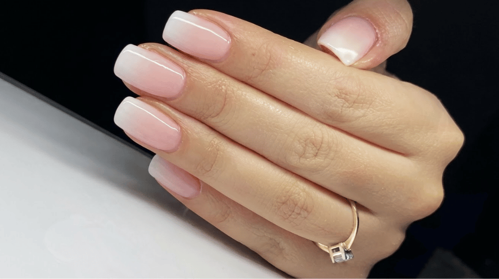 glossy square nails with a soft blush pink base fading toward milky white tips