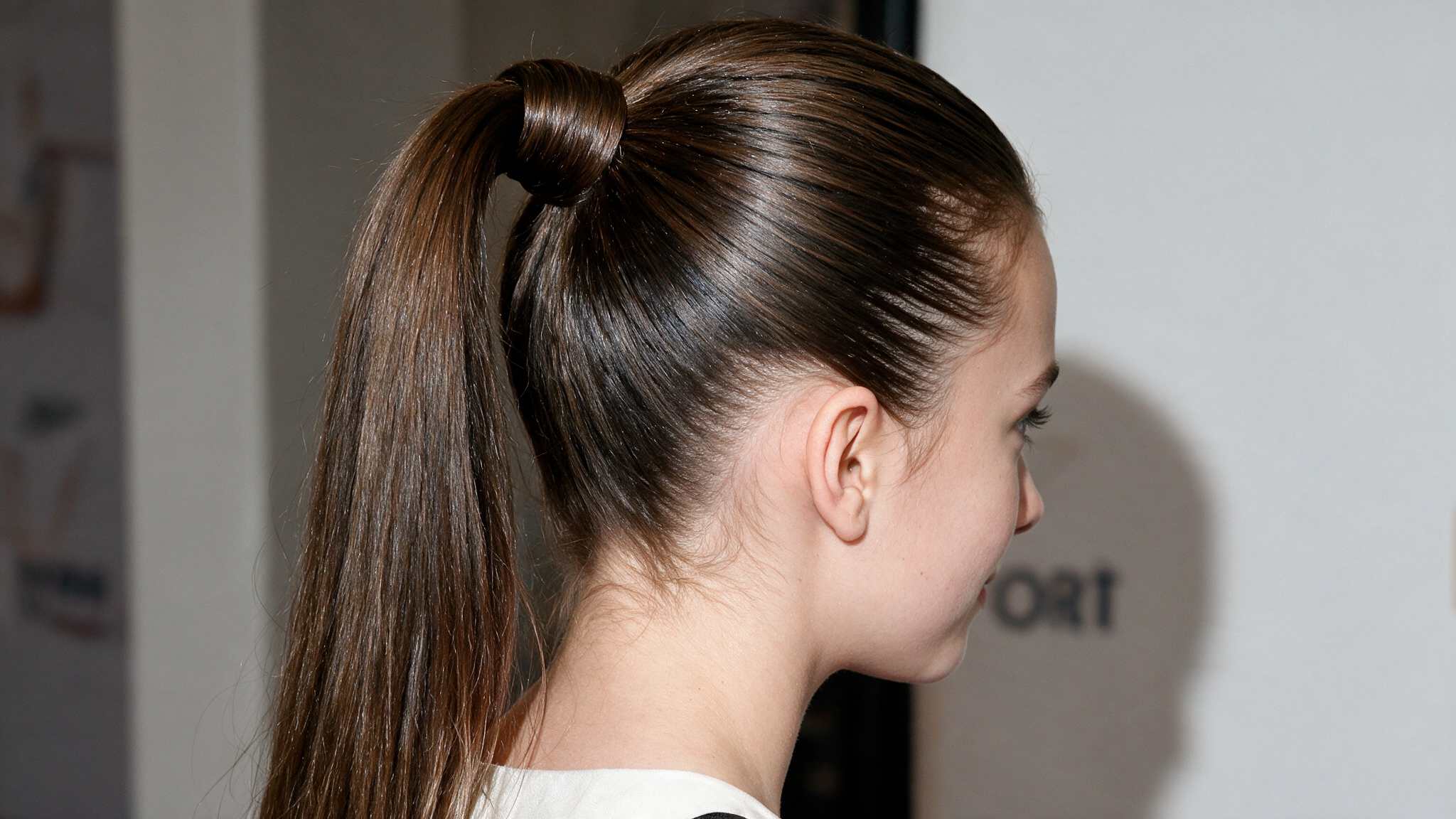 teen girl wearing sleek high ponytail with natural smooth hair texture